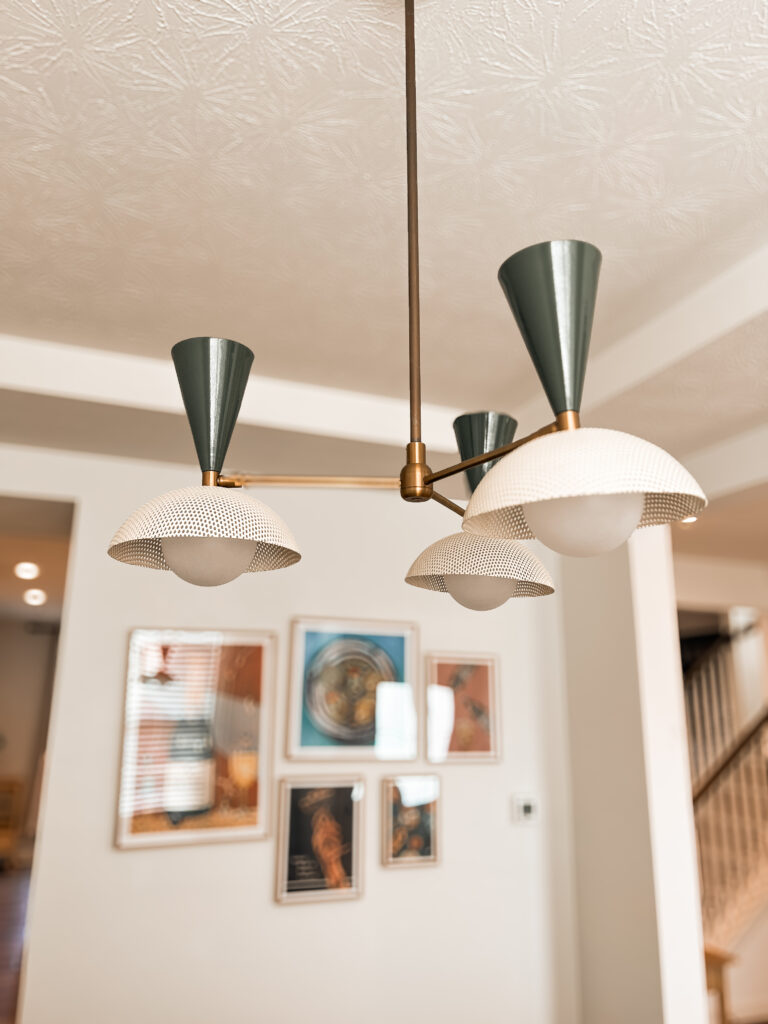 The Molto 3-Arm ceiling fixture offers a fresh take on Italian modernism, featuring a spun-metal mesh shade inspired by Mathieu Matégot's signature medium of Rigitulle. At once playful and sophisticated, the Molto chandelier is a go-anywhere design. The fixture shown has our Seaweed and Crema enamels and is finished with Brushed Brass.